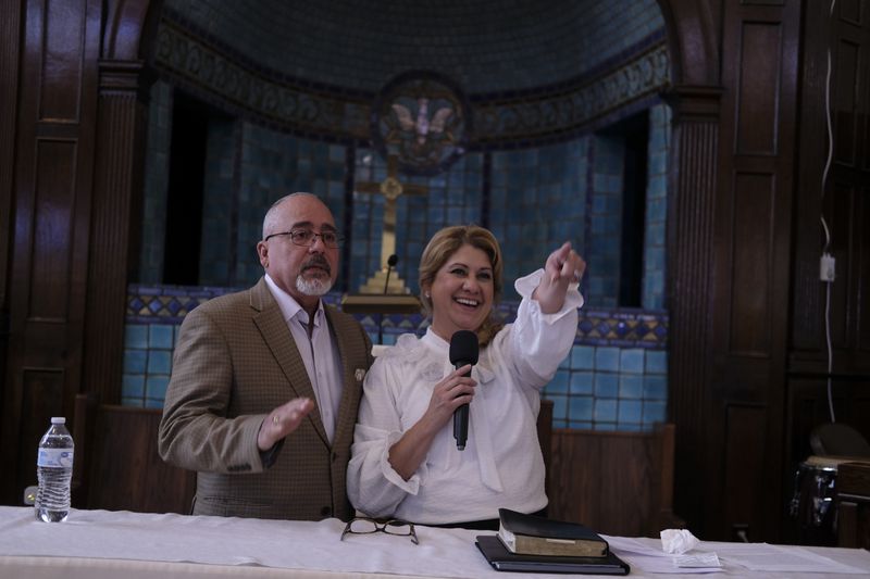 Pastors Carol Pagan and her husband, Jose, both from Puerto Rico, engage with parishioners on Sunday, June 9, 2024 at Iglesia Jesucristo es el Rey (Church Jesus Christ is the King), a thriving Latino congregation that shares the building with First Baptist Church in Reading, Pa. The pastors encourage parishioners to vote in the election — irrespective of who they choose as the president. (AP Photo/Luis Andres Henao)