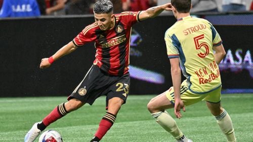 Atlanta United midfielder Thiago Almada (23) shoots against New York Red Bulls midfielder Peter Stroud (5) during the first half in a MLS soccer match at Mercedes-Benz Stadium, Saturday, April 1, 2023, in Atlanta. (Hyosub Shin / Hyosub.Shin@ajc.com)