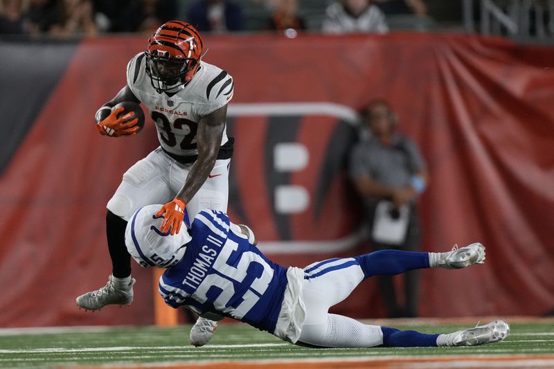 Cincinnati Bengals running back Trayveon Williams (32) is tackled by Indianapolis Colts safety Rodney Thomas II (25) during the first half of a preseason NFL football game, Thursday, Aug. 22, 2024, in Cincinnati. (AP Photo/Carolyn Kaster)