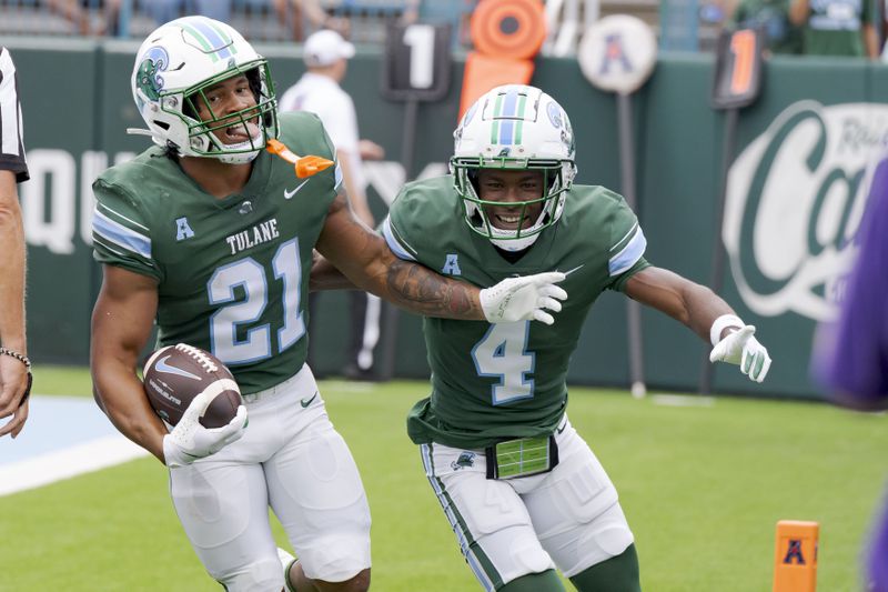 Tulane running back Makhi Hughes (21) celebrates a touchdown with wide receiver Mario Williams (4) during the first half of an NCAA college football game against Kansas State in New Orleans, Saturday, Sept. 7, 2024. (AP Photo/Matthew Hinton)