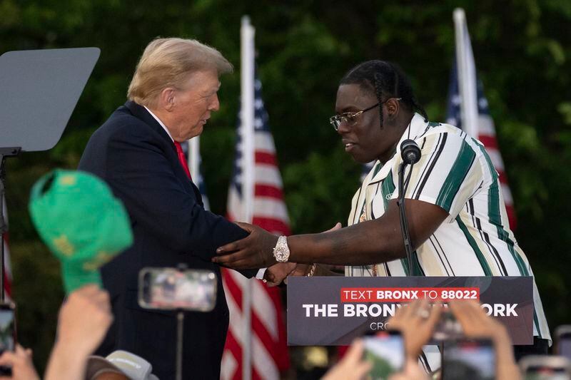 Rapper Sheff G, right, also known as Michael Williams, shakes hand with the Republican presidential candidate former President Donald Trump during a campaign rally in the south Bronx, Thursday, May. 23, 2024, in New York. (AP Photo/Yuki Iwamura)