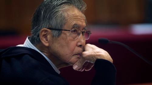 FILE - Peru's jailed, former President Alberto Fujimori, photographed through a glass window, attends his trial at a police base on the outskirts of Lima, Peru, June 28, 2016. (AP Photo/Martin Mejia, File)