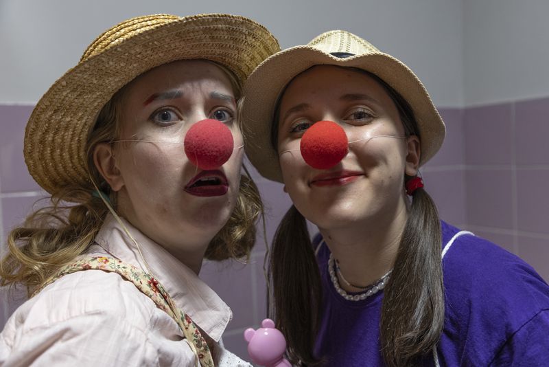 Vladyslava Kulinich, right, Tetiana Nosova, who have the clown names Lala and Zhuzha, pose for a photo as they prepare to perform at Okhmatdyt children's hospital in Kyiv, Ukraine, Thursday Sept. 19, 2024. (AP Photo/Anton Shtuka)