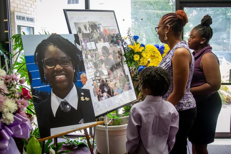 People look over the flowers and photographs before the start of funeral services Saturday for Imani Bell at the Hillside Chapel & Truth Center in Atlanta August 24, 2019. (Photo: STEVE SCHAEFER / SPECIAL TO THE AJC)