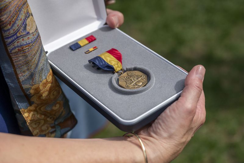 Alexia Collart holds The Navy and Marine Corps Medal, the USMCs highest non-combat medal, that was posthumously awarded to her son, Cpl. Spencer Collart, during a ceremony on Monday, Sept. 16, 2024 in Washington. (AP Photo/Kevin Wolf)