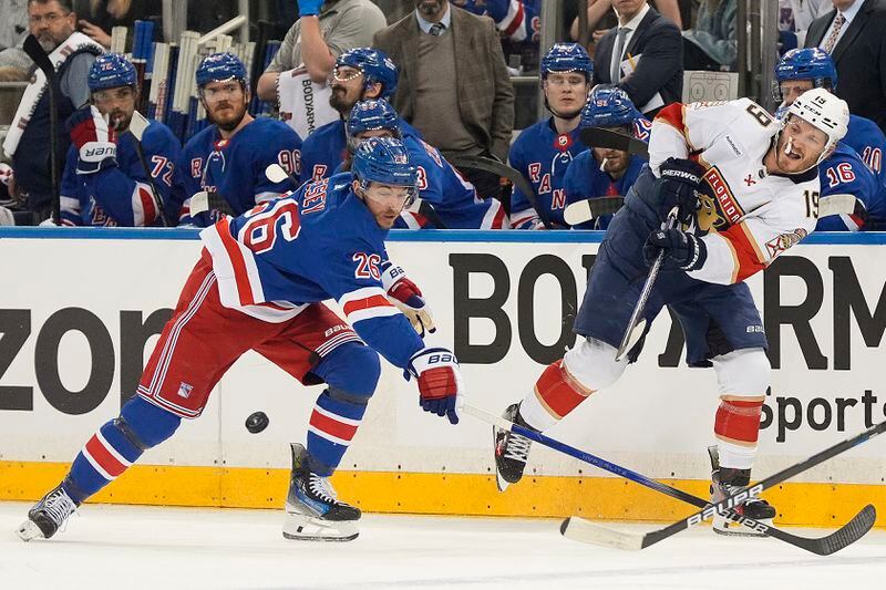 Florida Panthers left wing Matthew Tkachuk (19) passes the puck against New York Rangers left wing Jimmy Vesey (26) during the first period of Game 1 of the NHL hockey Eastern Conference Stanley Cup playoff finals, Wednesday, May 22, 2024, in New York. (AP Photo/Julia Nikhinson)
