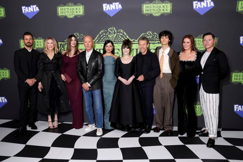 Justin Theroux, from left, Catherine O'Hara, Monica Bellucci, Michael Keaton, Jenna Ortega, Winona Ryder, Willem Dafoe, Arthur Conti, Amy Nuttall, and Burn Gorman arrive at the premiere of "Beetlejuice Beetlejuice" on Thursday, Aug. 29, 2024, in London. (Photo by Scott Garfitt/Invision/AP)