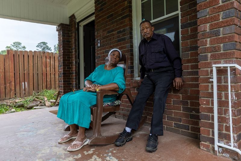 Dorothy and George Williams, who fell victim to a home repair scam, pose for a portrait in front of their home in Atlanta on Monday, May 13, 2024. (Arvin Temkar / AJC)