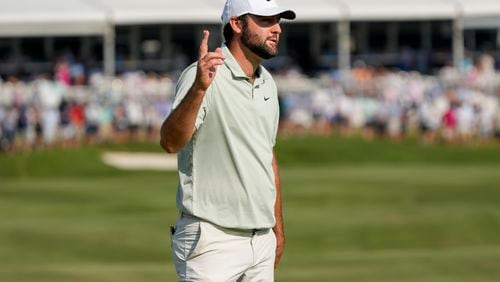 Scottie Scheffler waves after making a putt on the 18th green during the final round of the St. Jude Championship golf tournament Sunday, Aug. 18, 2024, in Memphis, Tenn. (AP Photo/Mark Humphrey)