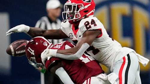 FILE - Alabama wide receiver Malik Benson (11) misses a pass against Georgia defensive back Malaki Starks (24) during the first half of the Southeastern Conference championship NCAA college football game in Atlanta, Saturday, Dec. 2, 2023. (AP Photo/Mike Stewart, File)