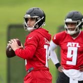 Atlanta Falcons quarterback Kirk Cousins (18) drops back to pass next to quarterback Michael Penix (9) during minicamp at the Atlanta Falcons Training Camp, Tuesday, May 14, 2024, in Flowery Branch, Ga. (Jason Getz / AJC)
