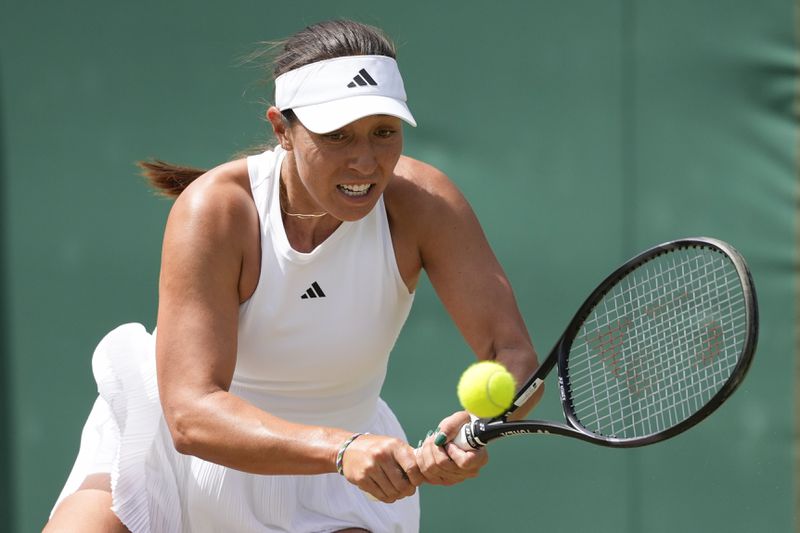 Jessica Pegula of the United States plays a backhand return to Xinyu Wang of China during their second round match at the Wimbledon tennis championships in London, Thursday, July 4, 2024. (AP Photo/Alberto Pezzali)