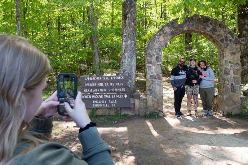 Zach Cross poses for a photo with his parents Tim and Jody at the arch at the beginning of the approach trail to the Appalachian Trail on Monday just before he started his thru-hike.  (Ben Gray / Ben@BenGray.com)