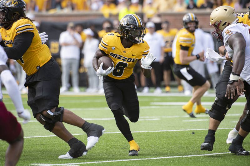 Missouri running back Nate Noel (8) scrambles for yardage during the first half of an NCAA college football game against Boston College, Saturday, Sept. 14, 2024, in Columbia, Mo. (AP Photo/L.G. Patterson)