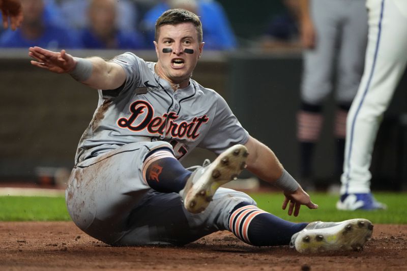 Detroit Tigers' Jace Jung slides home to score on a double by Trey Sweeney during the third inning of a baseball game against the Kansas City Royals Wednesday, Sept. 18, 2024, in Kansas City, Mo. (AP Photo/Charlie Riedel)