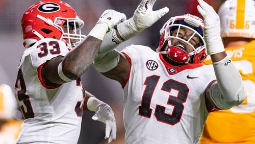 FILE - Georgia defensive lineman Mykel Williams (13) and linebacker C.J. Allen (33) react to a sack on Tennessee quarterback Joe Milton III (7) during the second half of an NCAA college football game Saturday, Nov. 18, 2023, in Knoxville, Tenn. (AP Photo/Wade Payne, File)