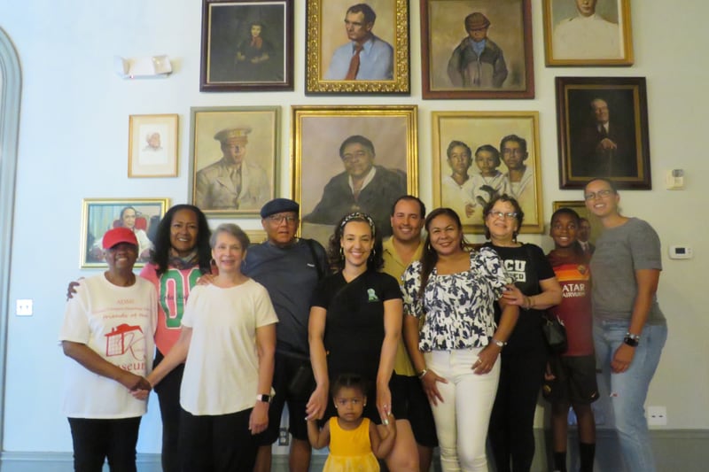 Members of the Kiah family in front of art displayed at Clarence Thomas Building.