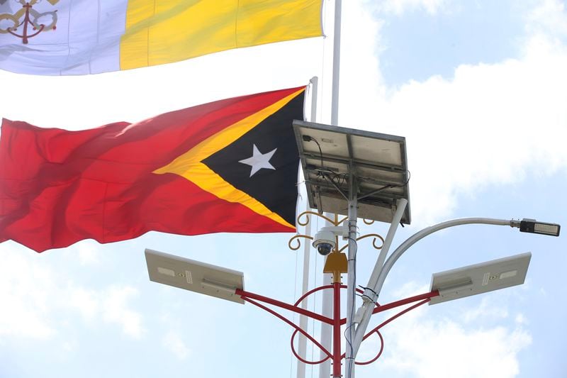 A solar panel is seen next to an East Timor national flag in Dili, East Timor, Friday, Sept. 6, 2024. (AP Photo/Firdia Lisnawati)