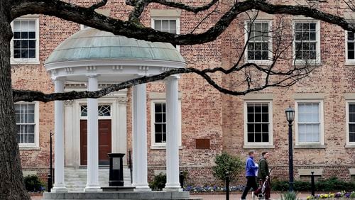 FILE - People remove belongings on campus at the University of North Carolina in Chapel Hill, N.C., March 18, 2020. (AP Photo/Gerry Broome, File)