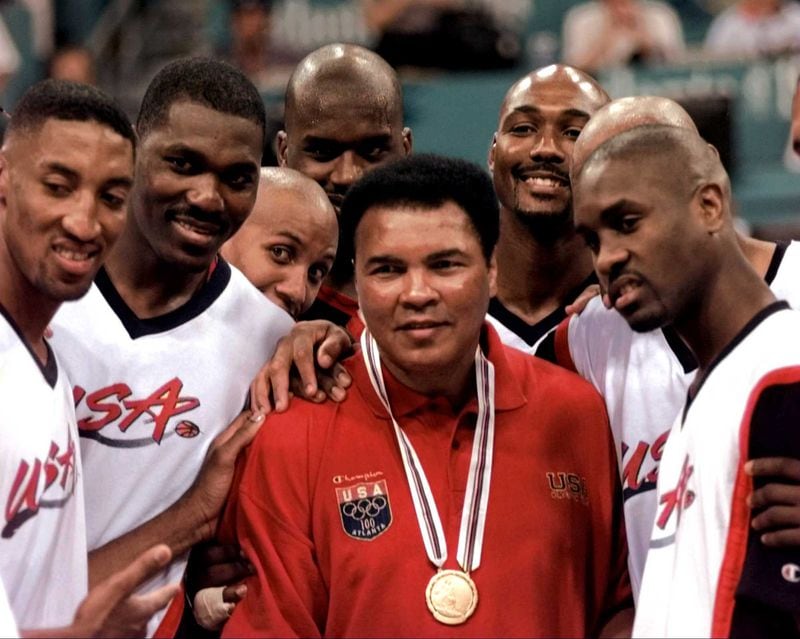 Muhammad Ali poses with Dream Team members Scottie Pippen (from left), Hakeem Olajuwon, Reggie Miller, Shaquille O'Neal, Karl Malone and Gary Payton after receiving the gold medal - to replace the 1960 gold medal he lost -  during a half time ceremony at the men's basketball final of the Centennial Summer Olympic Games Saturday, Aug. 3, 1996, in Atlanta. IOC president Juan Antonio Samaranch presented the medal to Ali. (Eric Draper/AP)