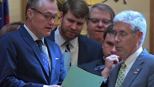 Lt. Gov. Casey Cagle (left) confers with state Sen. Bill Heath (right) and other senators during the winter session of the Legislature. HYOSUB SHIN / HSHIN@AJC.COM