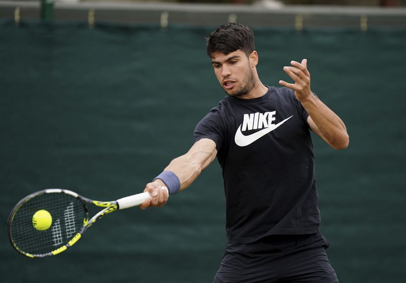 Spain's Carlos Alcaraz plays a shot on the practice court at the All England Lawn Tennis and Croquet Club, ahead of the Wimbledon Championships, which begins on July 1st, in London, Friday June 28, 2024. (Zac Goodwin/PA via AP)