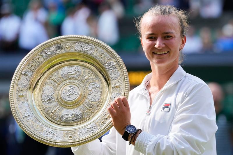 Barbora Krejcikova of the Czech Republic holds her trophy after defeating Jasmine Paolini of Italy in the women's singles final at the Wimbledon tennis championships in London, Saturday, July 13, 2024. (AP Photo/Kirsty Wigglesworth)