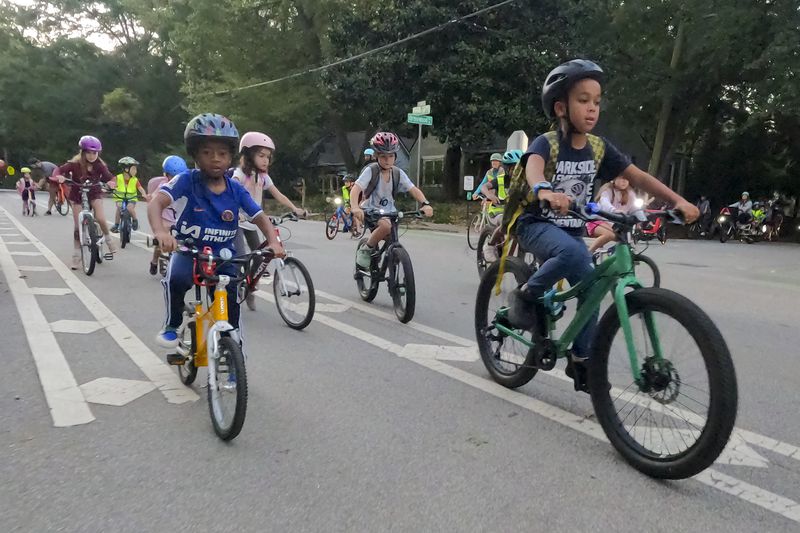 Participants in the weekly Parkside Elementary School “bike bus” head towards the school Friday, Sept. 20, 2024, in Atlanta. Ben Gray for the Atlanta Journal-Constitution