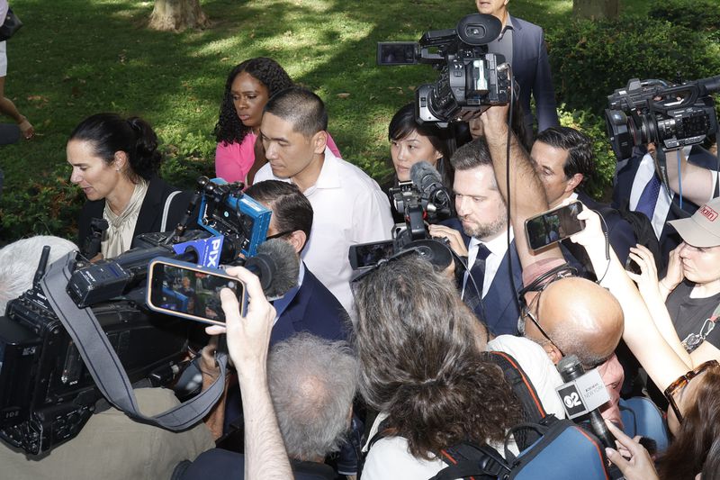 Former New York Governor Kathy Hochul aide Linda Sun, center background, and her husband, Christopher Hu leave Brooklyn Federal Court after their arraignment, Tuesday, Sept. 3, 2024, in New York. (AP Photo/Corey Sipkin)