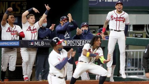 It's fun to score a lot of runs. Various Braves enjoy Marcell Ozuna's double during the big six-run sixth inning Thursday in Game 4 of NLCS vs. the Los Angeles Dodgers. (Curtis Compton / Curtis.Compton@ajc.com)