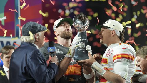 Kansas City Chiefs players Travis Kelce and Patrick Mahomes celebrate with the trophy after winning the Super Bowl LVII against Philadelphia Eagles at State Farm Stadium in Glendale, Ariz., on Feb. 12, 2023. (Doug Mills/The New York Times