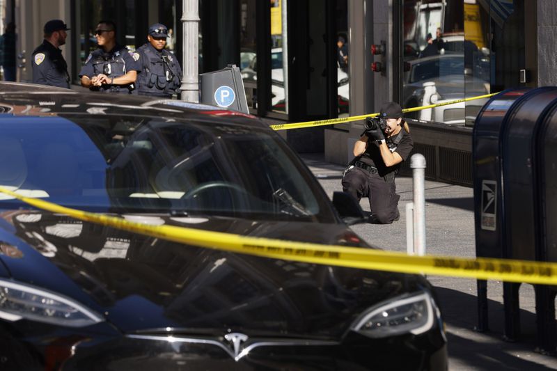 Police officers secure the area and investigate the scene of a shooting at Union Square in San Francisco, Saturday, Aug. 31, 2024. (Santiago Mejia/San Francisco Chronicle via AP)