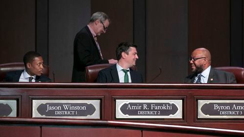 Council members Jason Winston (from left), Howard Shook, Amir R. Farokhi and Byron Amos confer as the Atlanta City Council held their first in person meeting since they were suspended at start of the pandemic In Atlanta on Monday, March 21, 2022.   (Bob Andres / robert.andres@ajc.com)