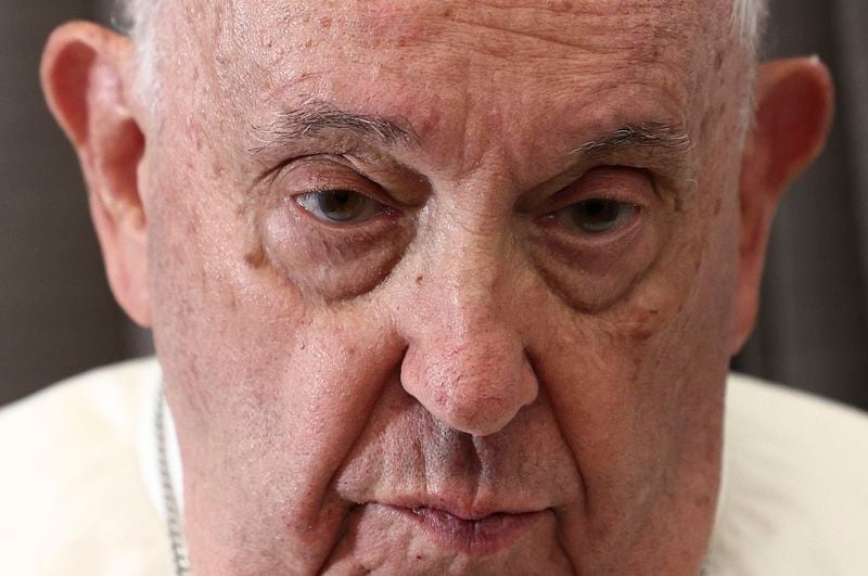 Pope Francis attends a news conference aboard the papal plane on his flight back after his 12-day journey across Southeast Asia and Oceania, Friday, Sept. 13, 2024. (Guglielmo Mangiapane/Pool Photo via AP)