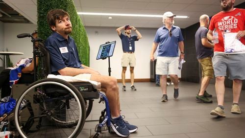 Atlanta Braves greeter Wilson Barron rests in his wheelchair as he works in an elevator lobby before the Braves play the New York Mets at Truist Park, Tuesday, Sept. 24, 2024, in Atlanta. (Jason Getz / AJC)

