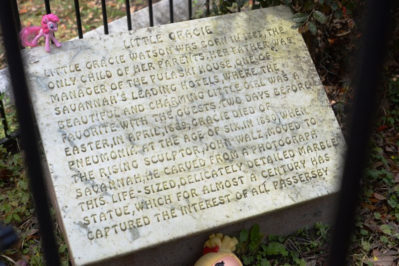 Travelers visit the grave of "Little Gracie," one of the world's most-visited graves, in Bonaventure Cementery in Savannah, Ga. on Friday, March 18, 2016. Gracie Watkins died in Savannah in 1889 after suffering from pneumonia.