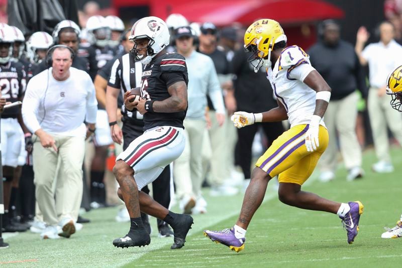 South Carolina quarterback LaNorris Sellers (16) gets out of bounds before LSU cornerback Ashton Stamps (1) can make contact during the first half of an NCAA college football game Saturday, Sept. 14, 2024 in Columbia, S.C. (AP Photo/Artie Walker Jr.)