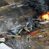 Debris from a Norfolk Southern freight train lies scattered and burning along the tracks on Feb. 4, 2023, the day after it derailed in East Palestine, Ohio. (Gene J. Puskar/AP)