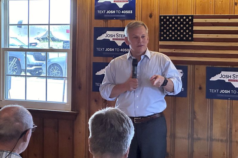 North Carolina Democratic gubernatorial candidate Josh Stein speaks with supporters at a campaign event at Wilber's Barbecue in Goldsboro, N.C., on Wednesday, Aug. 21, 2024. (AP Photo/Gary D. Robertson)