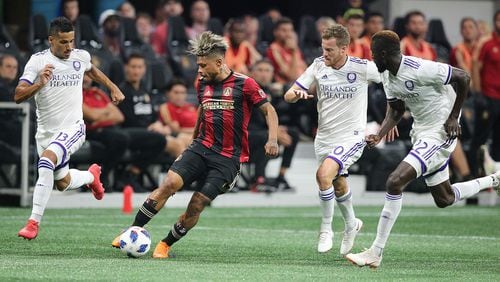 Atlanta United Josef Martinez works the ball through three Orlando City defenders during the first half in a MLS soccer match on Saturday, June 30, 2018, in Atlanta.     Curtis Compton/ccompton@ajc.com