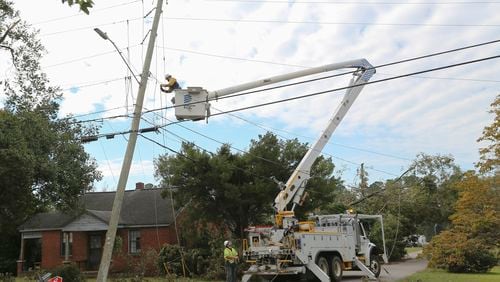 A Dominion Energy lineman works on a power line on Sept. 29 in the aftermath of Hurricane Helene in North Augusta, S.C. (Artie Walker Jr./AP)