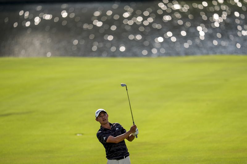 Collin Morikawa hits the ball on the 18th fairway during the first round of the Tour Championship golf tournament, Thursday, Aug. 29, 2024, in Atlanta. (AP Photo/Mike Stewart)