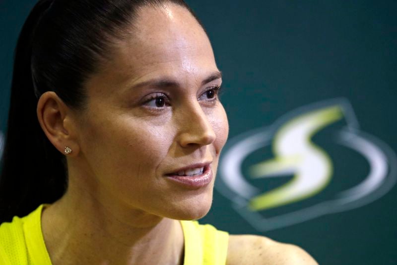 FILE - Seattle Storm's Sue Bird talks with media members at the basketball team's media day in Seattle, May 13, 2019. Magic Johnson's love of basketball motivated him to save the Los Angeles Sparks from folding and also put him on the leading edge of what is now a growing WNBA trend. Former WNBA players Sue Bird and Renee Montgomery have joined the ownership groups of the Seattle Storm and Atlanta Dream, respectively. (AP Photo/Elaine Thompson, File)