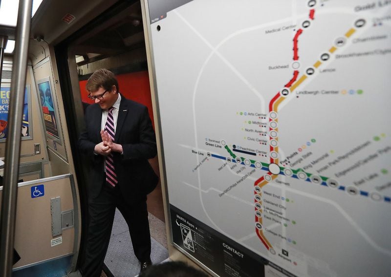 MARTA General Manager/CEO Jeffrey Parker boards a train at the Five Points station next to a map of the rail lines during a tour in March. MARTA rail service celebrates its 40th anniversary this year, and the agency is poised for expansion. Curtis Compton/ccompton@ajc.com