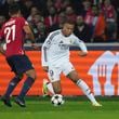 Real Madrid's Kylian Mbappe, right, dribbles the ball past Lille's Benjamin Andre during the Champions League opening phase soccer match between Lille and Real Madrid at the Stade Pierre Mauroy in Villeneuve-d'Ascq, outside Lille, France, Wednesday, Oct. 2, 2024. (AP Photo/Thibault Camus)