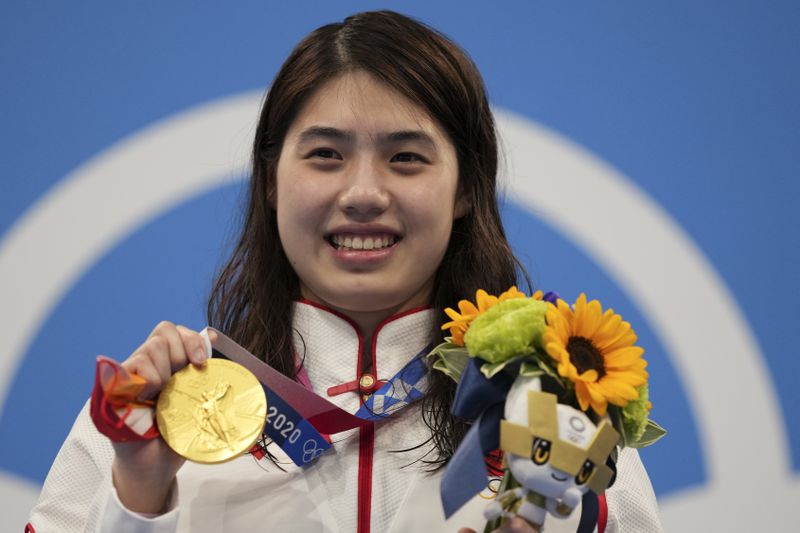 FILE - Zhang Yufei of China poses with her gold medal after winning the women's 200-meter butterfly final at the 2020 Summer Olympics, on July 29, 2021, in Tokyo, Japan. (AP Photo/Matthias Schrader, File)