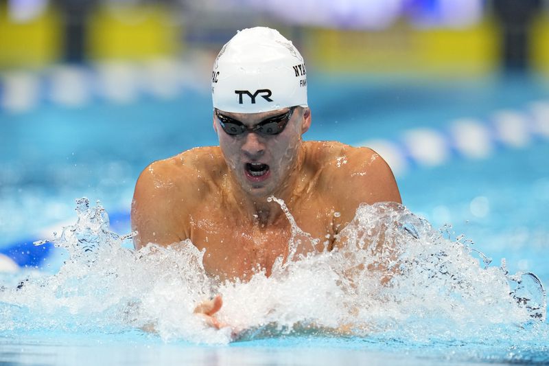 Nic Fink swims during the Men's 100 breaststroke preliminaries Saturday, June 15, 2024, at the US Swimming Olympic Trials in Indianapoils. (AP Photo/Michael Conroy)