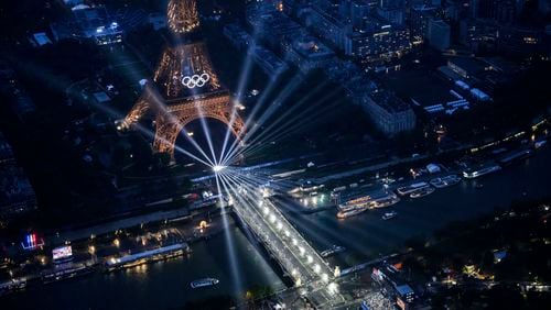 A photograph taken from a helicopter shows an aerial view of the Eiffel Tower and the Olympics Rings lightened up in Paris, France, during the opening ceremony for the 2024 Summer Olympics, Friday, July 26, 2024. (Lionel Bonaventure/Pool Photo via AP)