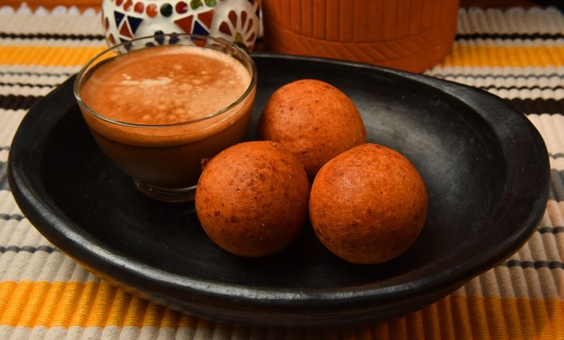 Colombian Buñuelos can serve as breakfast or a snack. Though they're shown here with coffee, they're perfect with hot chocolate, according to chef Christian Lopez. (Styling by Christian Lopez / Chris Hunt for the AJC)