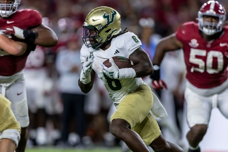 South Florida running back Kelley Joiner (8) runs the ball against Alabama during the second half of an NCAA college football game, Saturday, Sept. 7, 2024, in Tuscaloosa, Ala. (AP Photo/Vasha Hunt)